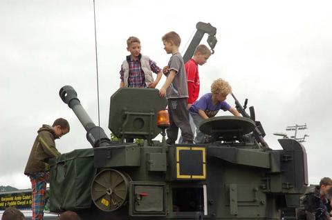 Ready for action: Children explore military tank