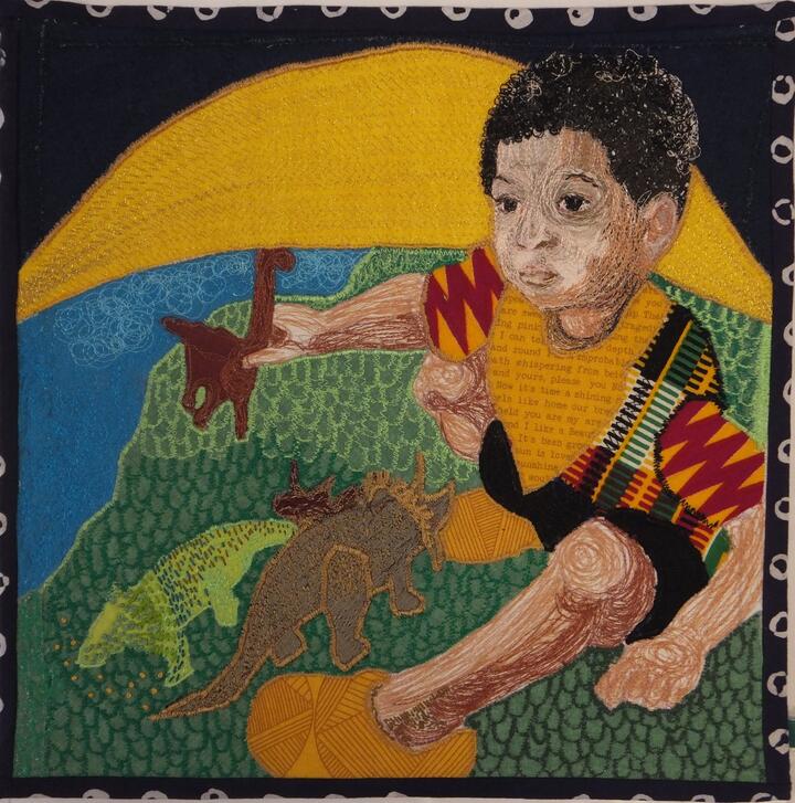 Appliqued and embroidered panel, created by Quakers working with the Loving Earth Project. A machine embroidered and appliqued panel shows little boy with brown skin and black curly hair sitting on the earth, playing with dinosaurs. The sun is rising directly behind him.
